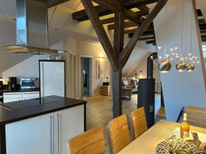 a kitchen and dining room with a table and chairs at Fachwerkliebe Baudenkmal Ornes in Olsberg