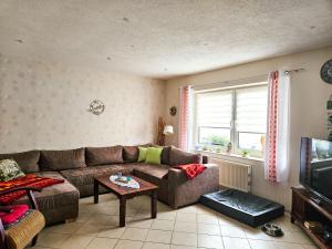 a living room with a couch and a table at hundefreundliches Ferienhaus in Kröslin