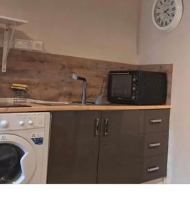 a kitchen with a microwave and a sink at Studios Saint dye sur Loire in Saint-Dyé-sur-Loire +9 photos