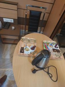 a table with a bowl of food and glasses on it at Orbit guest house by Flying Suites in Kolkata