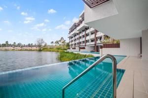 a swimming pool with a view of the water in a building at Angsana Oceanview Residences Building 2 in Laguna by Banyan Living in Bang Tao Beach