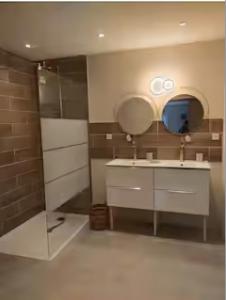 a bathroom with a sink and a mirror at Chambres - La Chenevelle in Chitenay +12 photos