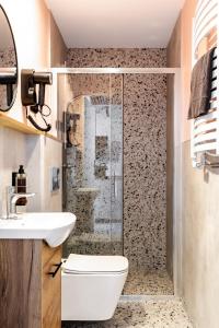 a bathroom with a shower and a toilet and a sink at New Adler Bed & Breakfast in Łódź +85 photos