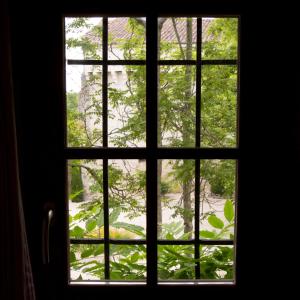 a window with a view of a tree at GITE FOUR A PAIN 4 pers in Bon-Encontre