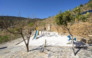 a beach with trees in the sand and a building at Matasiete in Laroya +11 photos