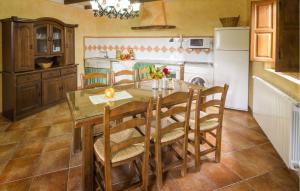 a kitchen with a dining table and a refrigerator at Matasiete in Laroya
