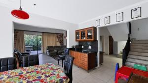 a kitchen and living room with a table and chairs at Konrad 8 in Uvongo Beach