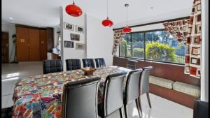 a dining room with a table and chairs at Konrad 8 in Uvongo Beach