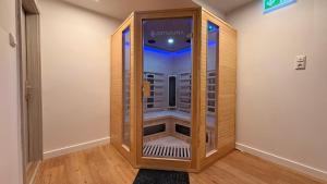 a walk in shower in a room with wood paneling at Attersee Panorama Apartments in Steinbach am Attersee