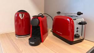 a red toaster and a toaster on a counter at Attersee Panorama Apartments in Steinbach am Attersee