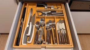 a drawer full of utensils in a box at Attersee Panorama Apartments in Steinbach am Attersee +86 photos