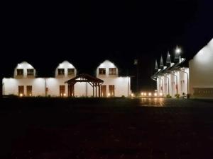 a large white building at night with lights at Apartament Konecka 2J in Sielpia Wielka