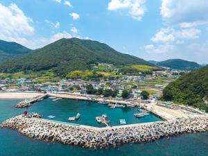 an aerial view of a harbor with boats in the water at Namhae Padosori Oceanview Pension in Namhae