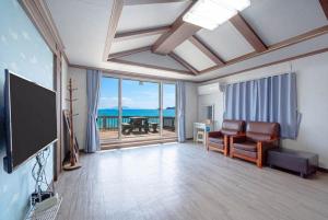 a living room with a view of the ocean at Namhae Padosori Oceanview Pension in Namhae +5 photos