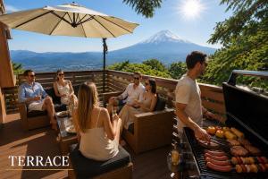 a group of people sitting on a deck with a mountain in the background at Ranked 1 in the Izu Mount Fuji from the villa in Izunokuni