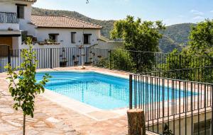 a swimming pool in front of a house at La Curiosa in Laroya