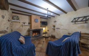 a living room with two beds and a fireplace at La Curiosa in Laroya