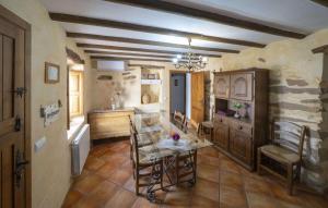 a kitchen with a table and chairs in a room at La Curiosa in Laroya