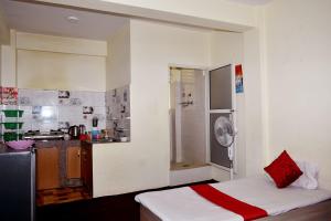 a small room with a bed and a kitchen at Kattel Homestay and Apartments in Bālāju