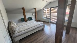 a bedroom with a bed and two chairs in it at Casa de oaspeti Minerva in Deva