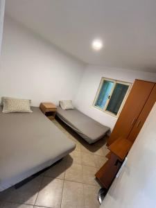 a room with two beds and a window at Apartmani Čanj in Čanj