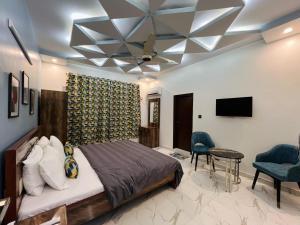 a bedroom with a bed and a ceiling fan at Karachi Inn in Karachi