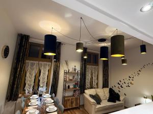 a living room with a table and a couch at Central Golden Apartment in Nowy Sącz