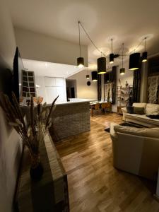 a living room with a couch and a table at Central Golden Apartment in Nowy Sącz