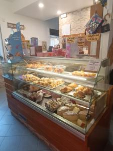 a bakery display case with many different types of pastries at Maurin in Carrara