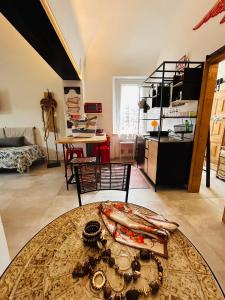 a living room with a table and a kitchen at Tati's Home CHARME & BIKERS in Mandello del Lario