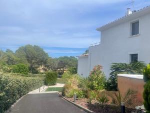 a driveway leading to a white house at VILLA MESSILIA Guest Rooms French Riviera in Saint-Raphaël