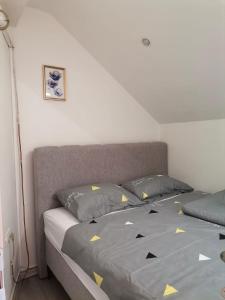 a bedroom with a bed with yellow triangles on it at Apartman Nik-Rom 1 in Bosanska Gradiška