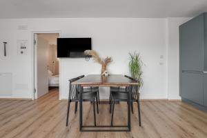 a dining room with a table and chairs at Mountain View Suites in Tesimo