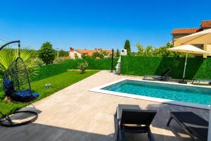 a backyard with a swimming pool and a playground at Villa Riviera in Nedeščina +41 photos