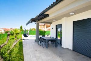 a patio with a black table and chairs at Villa Riviera in Nedeščina