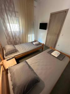 a bedroom with two beds and a mirror at Sunset Apartment A-4 in Perea