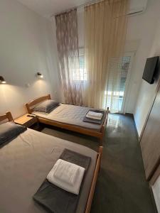 a bedroom with two beds and a television in it at Sunset Apartment A-4 in Perea