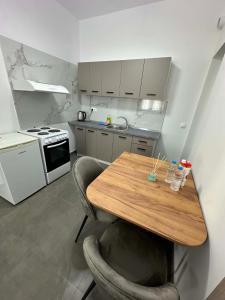 a kitchen with a wooden table and two chairs at Sunset Apartment A-4 in Perea