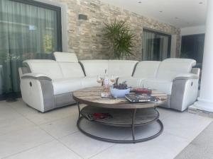 a living room with white couches and a table at VILLA MESSILIA Guest Rooms French Riviera in Saint-Raphaël