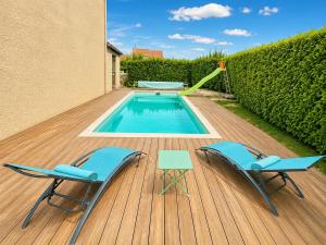 a deck with two chairs and a swimming pool at " Parenthèse Muretaine " Terrasse - Piscine - Wifi in Muret