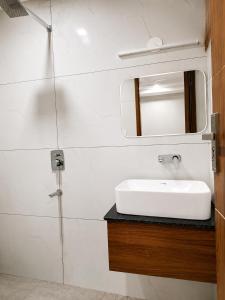 a bathroom with a white sink and a mirror at hotel glory in Haridwār