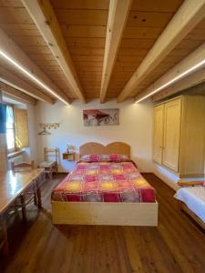 a bedroom with a bed and a wooden ceiling at ALBERGO DIFFUSO ORNICA NEL CUORE in Ornica