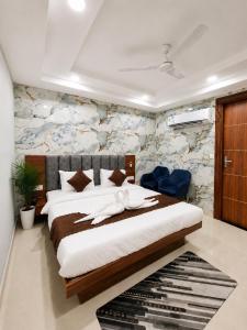a bedroom with a large bed in a room at hotel glory in Haridwār +4 photos