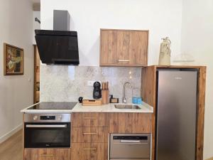 a kitchen with a stainless steel refrigerator and a sink at Monção Golden I in Monção +22 photos