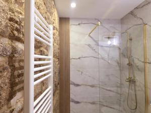 a bathroom with a shower with a glass door at Monção Golden I in Monção
