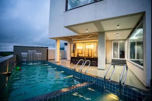 a swimming pool in the backyard of a house at Evara Sky Jacuzzi Villa in Igatpuri +11 photos