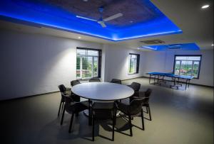 a room with a table and chairs and a blue ceiling at Evara Sky Jacuzzi Villa in Igatpuri