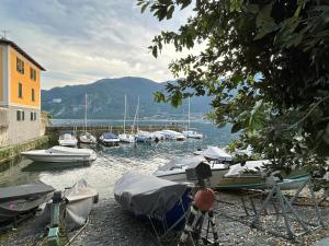 a group of boats are docked in a harbor at Tati's Home CHARME & BIKERS in Mandello del Lario