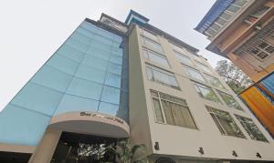 a building with a sign on the side of it at Dee Empresa Hotel in Kolkata