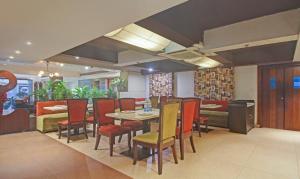 a dining room with a table and chairs at Dee Empresa Hotel in Kolkata